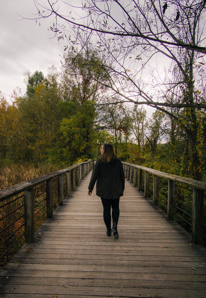 Woman walking on boardwalk