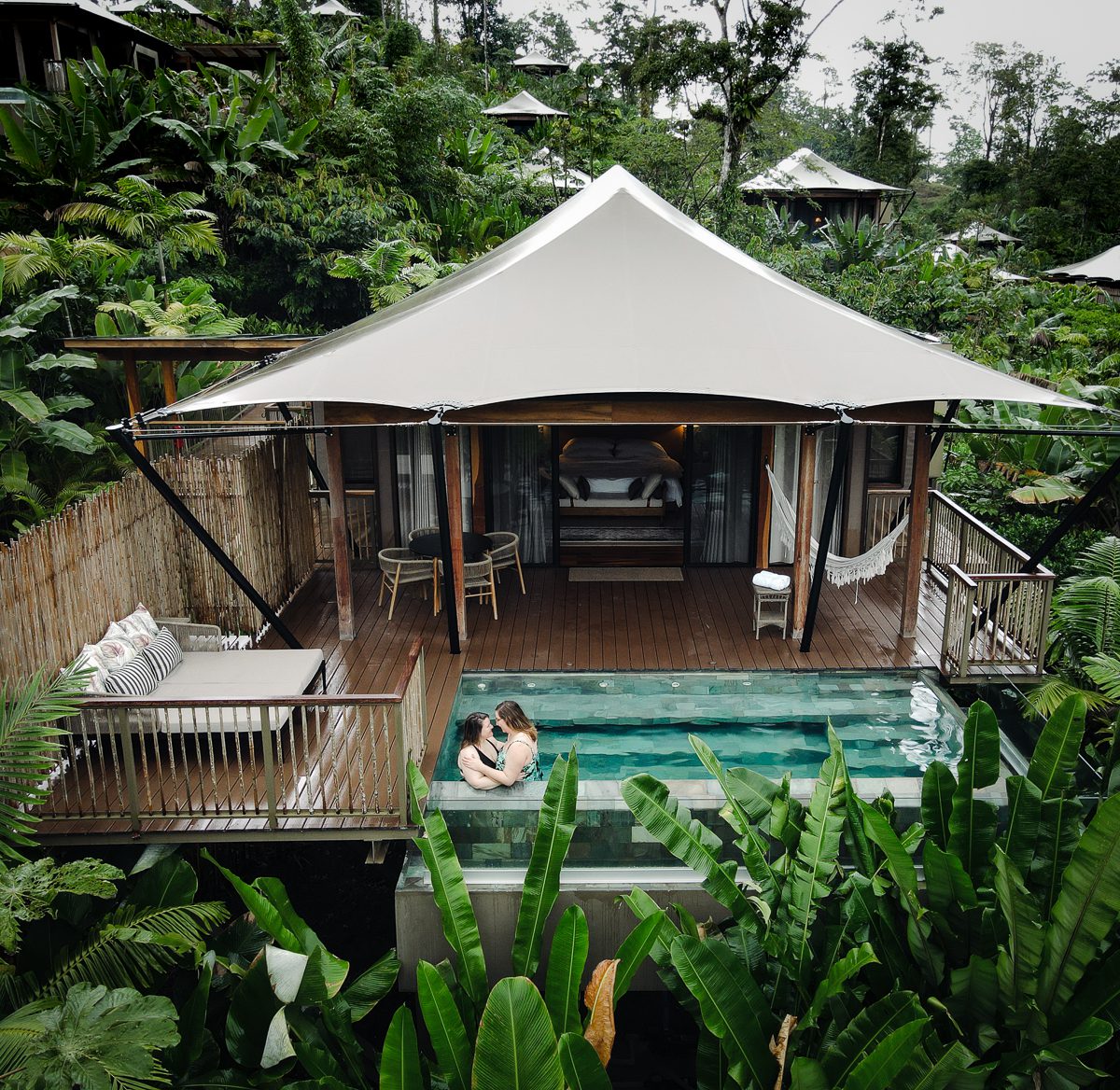 Lesbian couple in pool at Nayara Tented Camp