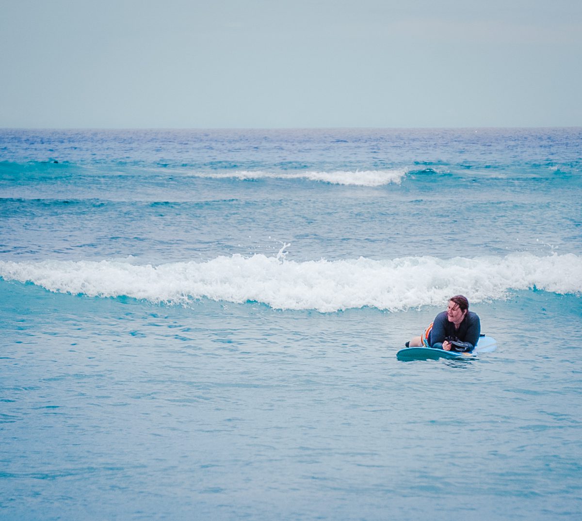 Woman smiling on surfboard in Maui