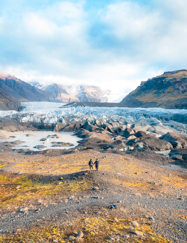 Tiny couple in the distance at Svinafellsjokull Glacier Viewpoint on Iceland five day ring road itinerary